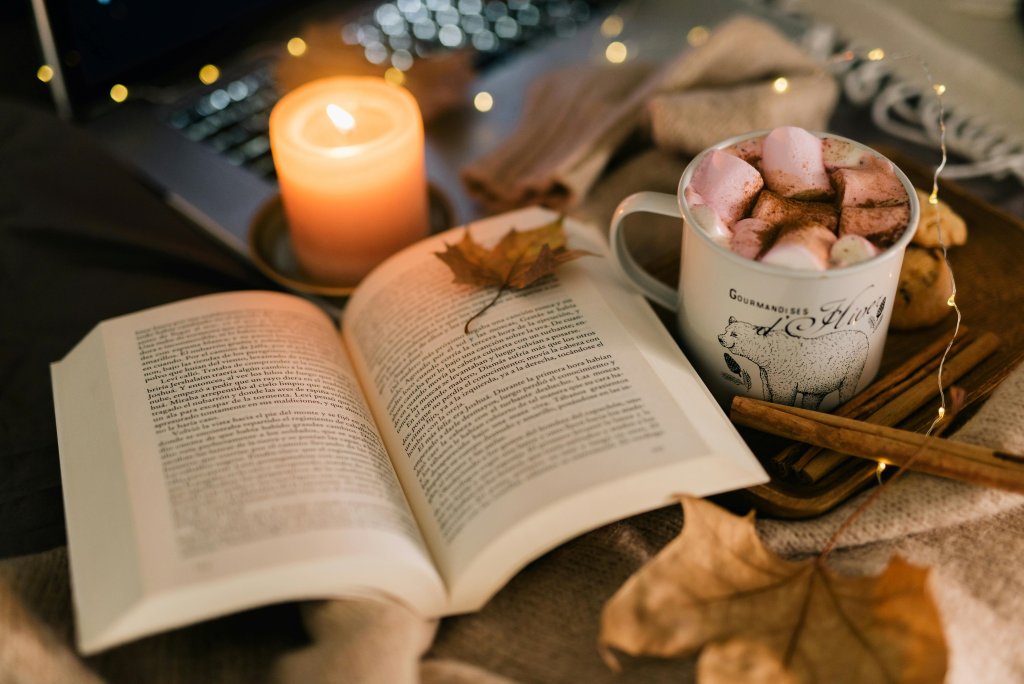 Fall Reading Book With Candles In Cozy Blanket