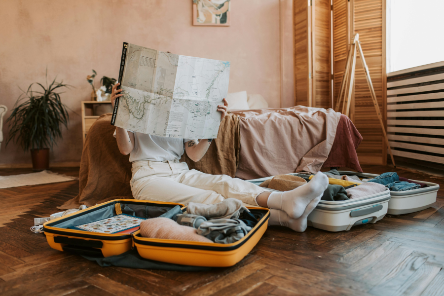 Suitcases Sitting and Reading a Map